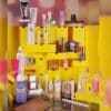 Products from the Selfridges Advent Calendar 2026 arranged around the open yellow box