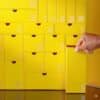 Yellow numbered drawers of the Selfridges Advent Calendar 2026, a hand opening a door