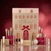 Catrice House Of Gold advent calendar 2026, closed box with red bow surrounded by all 24 products