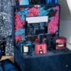 Close-up of the Guerlain Advent Calendar 2026 open, with a Guerlain candle, a Shalimar miniature and an Abeille Royale cream on display