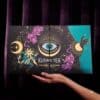 Kusmi Tea Advent Calendar 2026 box held in hands over velvet