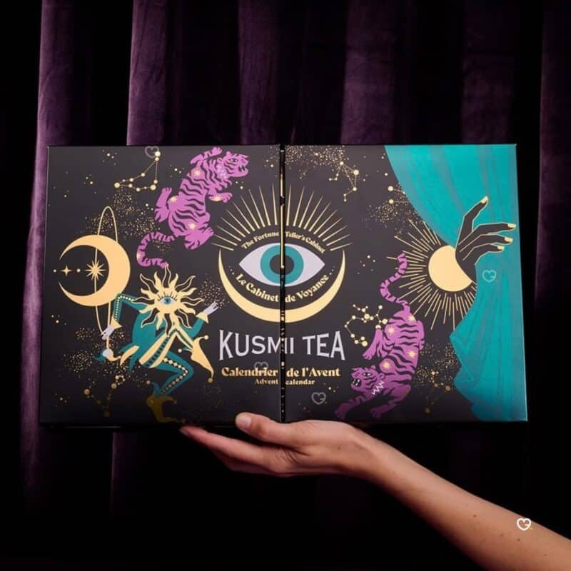 Kusmi Tea Advent Calendar 2026 box held in hands over velvet