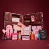 PrettyLittleThing Beauty Advent Calendar 2026 full contents laid out, 24 make-up, skincare and fragrance products