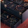 Numbered drawers of the Astley Clarke advent calendar revealing gold jewellery