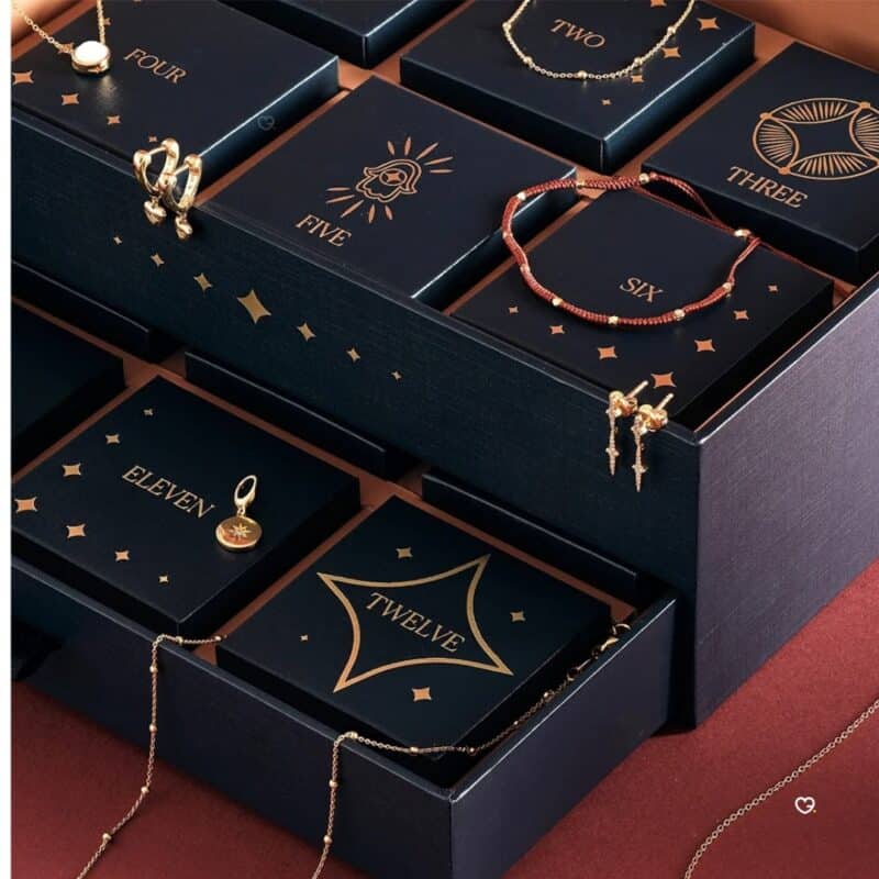 Numbered drawers of the Astley Clarke advent calendar revealing gold jewellery
