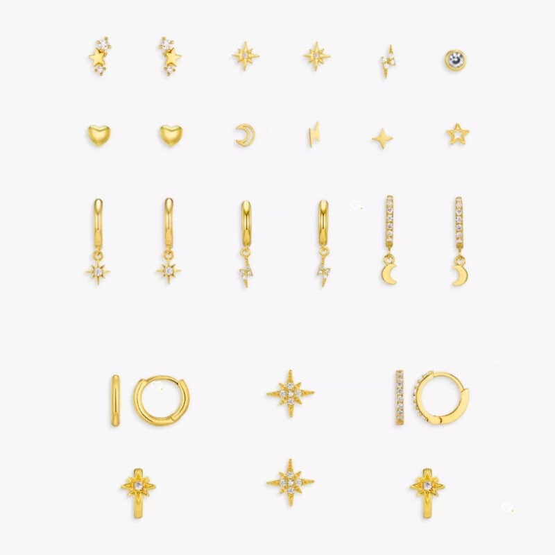 The full set of gold-plated earrings from the Orelia advent calendar 2026 laid flat, hoops and studs