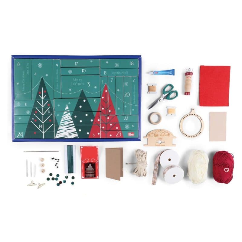 All the Prym Advent Calendar tools and materials laid out: scissors, textile glue, wool, felt, ribbons and beads