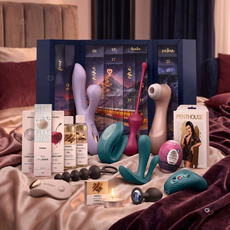 Contents of the Satisfyer Premium sex toy advent calendar 2026 arranged on a bed